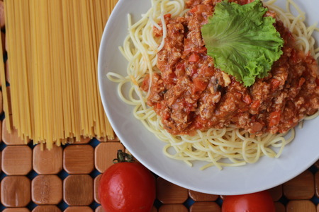 Spaghetti in a white plate and sliced sugar with red ketchupの写真素材