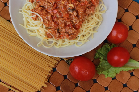 Spaghetti in a white plate and sliced sugar with red ketchupの写真素材
