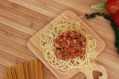 Spaghetti in a white plate and sliced sugar with red ketchupの写真素材