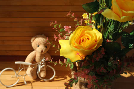 Yellow roses are arranged in bouquets on a brown backgroundの写真素材