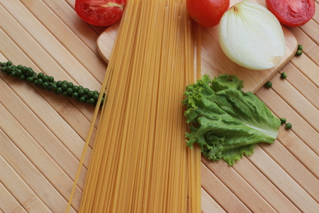 Spaghetti in a white plate and sliced sugar with red ketchupの写真素材