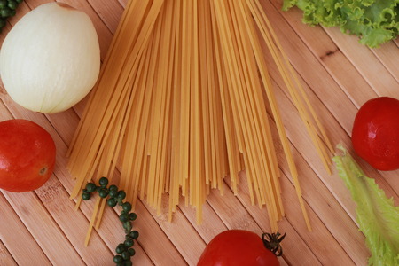 Spaghetti in a white plate and sliced sugar with red ketchupの写真素材