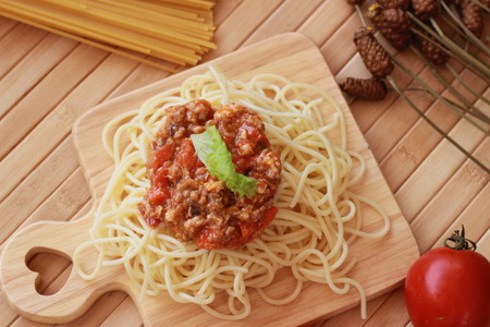 Spaghetti in a white plate and sliced sugar with red ketchupの写真素材