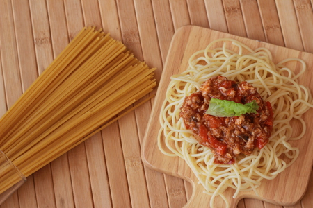 Spaghetti in a white plate and sliced sugar with red ketchupの写真素材