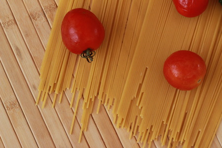 Spaghetti in a white plate and sliced sugar with red ketchupの写真素材