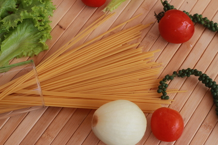 Spaghetti in a white plate and sliced sugar with red ketchupの写真素材