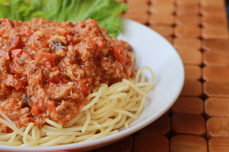 Spaghetti in a white plate and sliced sugar with red ketchupの写真素材