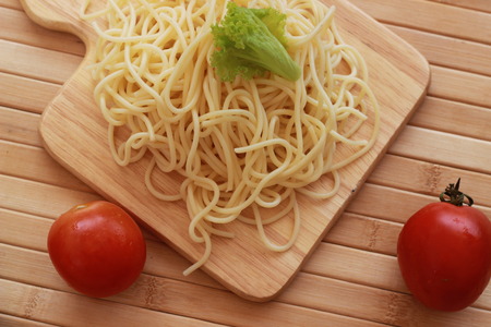 Spaghetti in a white plate and sliced sugar with red ketchupの写真素材