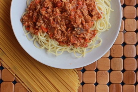 Spaghetti in a white plate and sliced sugar with red ketchupの写真素材
