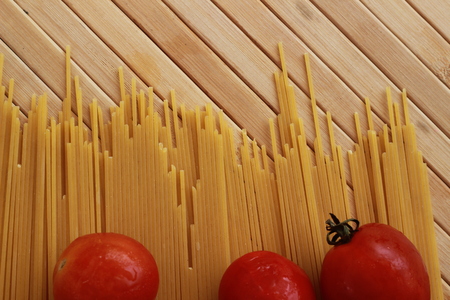 Spaghetti in a white plate and sliced sugar with red ketchupの写真素材