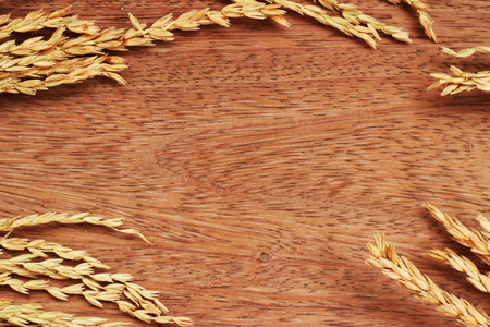 A brown grass bouquet is placed on a brown backgroundの写真素材