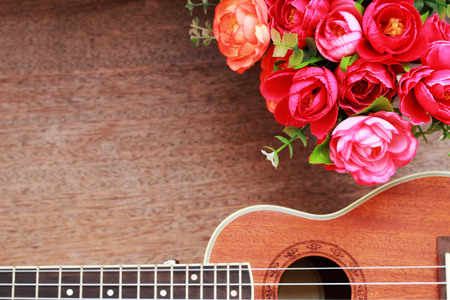 Brown Ukulele Lay on Old Brown Wood Tableの写真素材