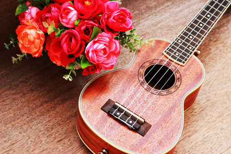 Brown Ukulele Lay on Old Brown Wood Tableの写真素材