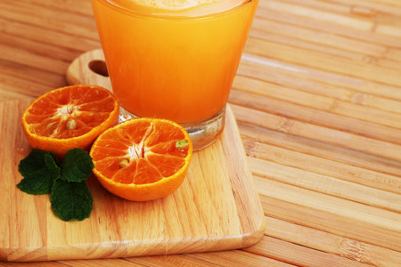 Orange juice blended and orange on a brown wooden tableの写真素材