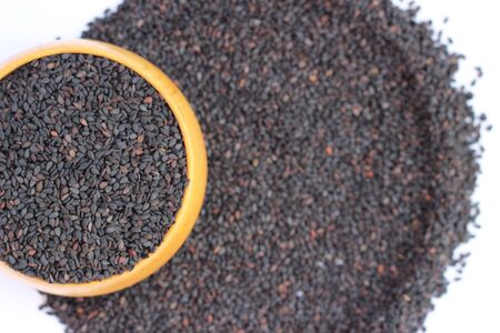 Black sesame in a brown cup on a white backgroundの写真素材