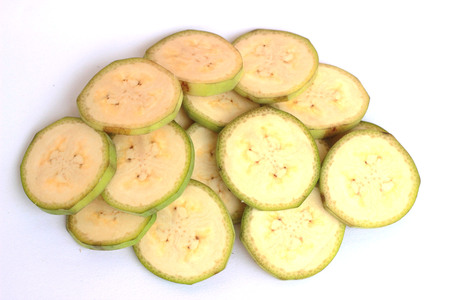 Raw bananas are cut together on a white backgroundの写真素材