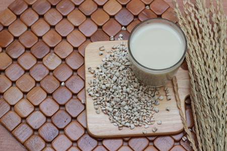 Coix lacryma-jobi, boiled in a glass on a brown background.の写真素材