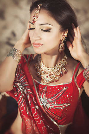 Beautiful young indian woman in traditional clothing with bridal makeup and jewelry  の写真素材