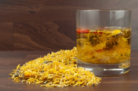 Camomile tea on brown bacground.の写真素材