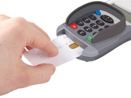 Someone inserting a debit-/credit-card with chip into a payment terminal, on white backgroundの写真素材