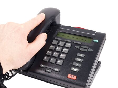 Someone lifting the handset on a office phone, isolated on white backgroundの写真素材