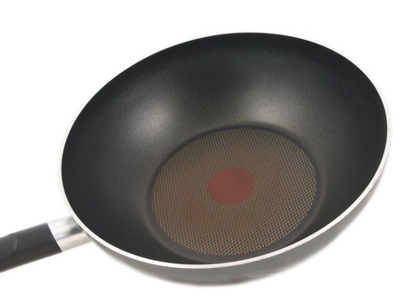 Frying pan with red hot spot isolated towards white backgroundの写真素材