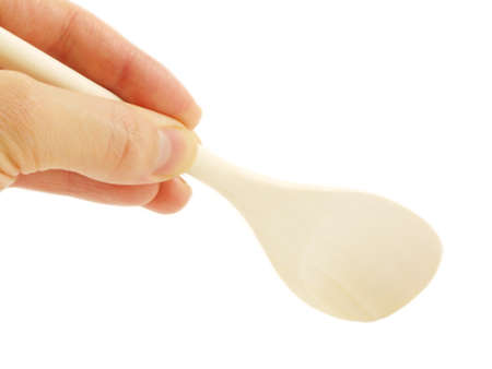 Person holding a wooden spatula, isolated towards white backgroundの写真素材