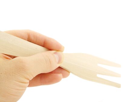 Person holding a wooden spatula fork, isolated towards white backgroundの写真素材