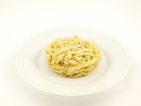 Round noodle, isolated on white plate, towards white backgroundの写真素材