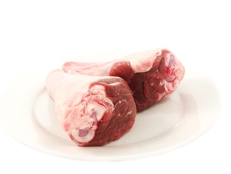 Fresh red meat, chops isolated on white plateの写真素材