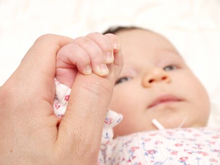 Baby holding handsの写真素材