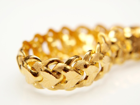 Yellow gold jewelry, isolated towards white backgroundの写真素材