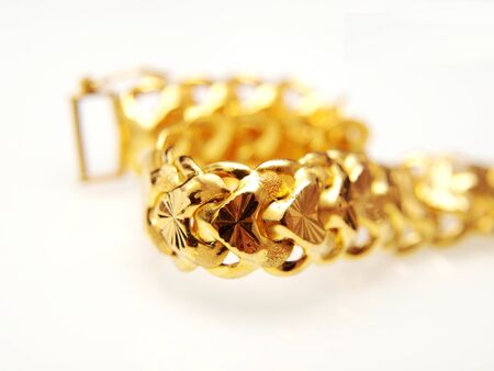 Yellow gold jewelry, isolated towards white backgroundの写真素材