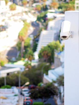 Security video camera on outside wall of a building