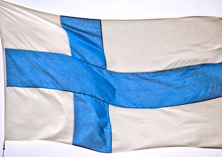 Flag of Finland waving in the wind, on a poleの写真素材