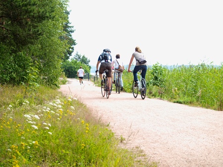 Bikers on little gravel road, at summerの写真素材