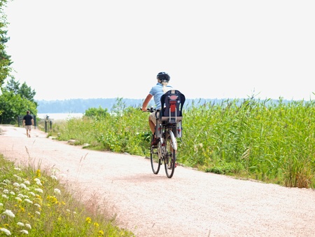 Biker on little gravel road, at summerの写真素材