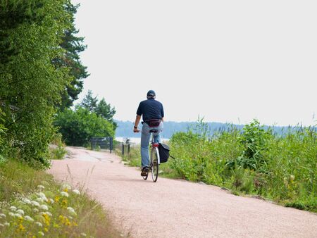 Biker on little gravel road, at summerの写真素材
