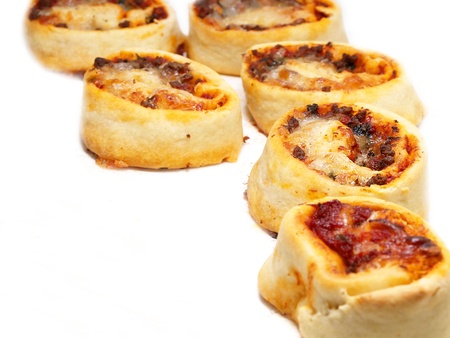 Small sized round pizza portions, in groups, towards whiteの写真素材