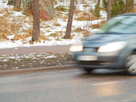 Car in high speed captured with blury motion on wintry conditionsの写真素材