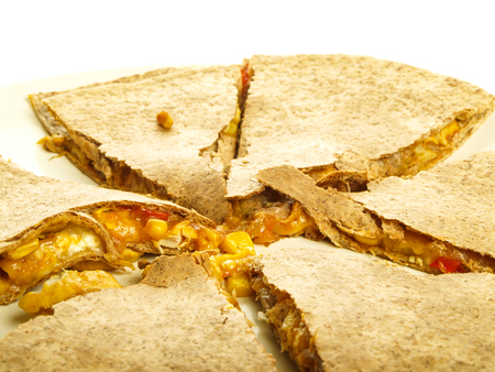 Oatmeal quesadillas in slices on white plate towards whiteの写真素材