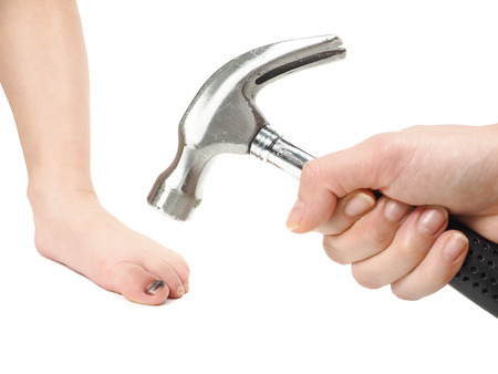 Someone holding a hammer over a childの写真素材