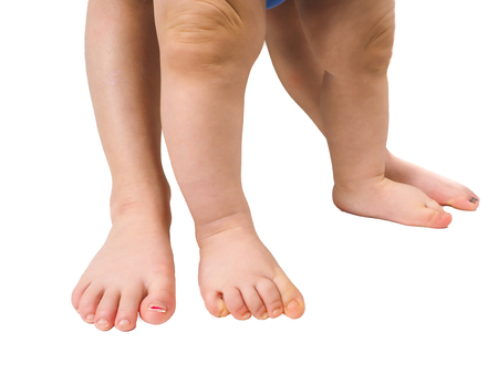 Barefoot young children standing towards isolated white backgroundの写真素材