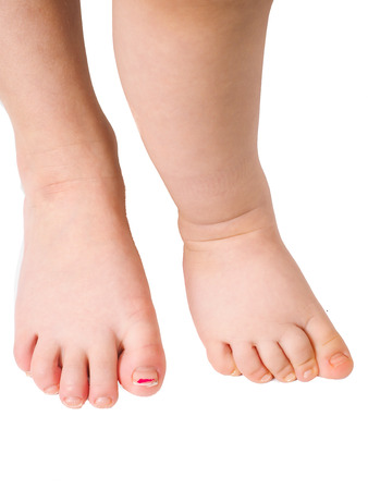 Barefoot young children standing towards isolated white backgroundの写真素材