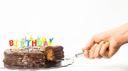 Female person serving a homemade sacher chocolate cake with birthday candles