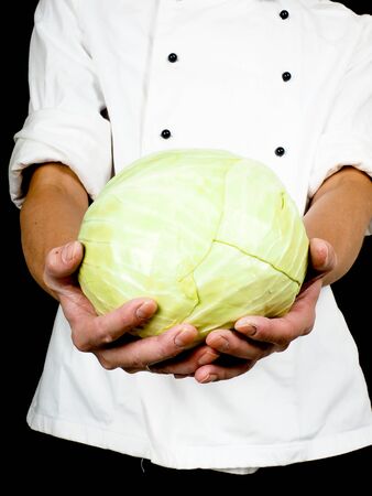 Professional chef holding a whole head of cabbage towardsの写真素材