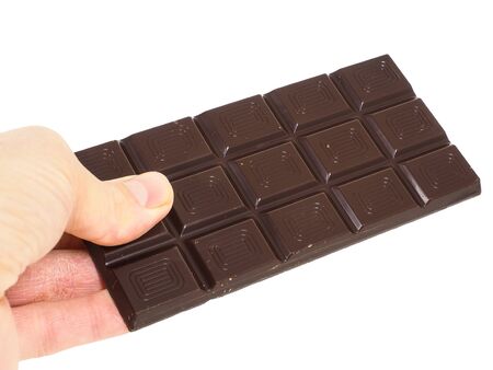 Person holding a whole bar of dark chocolate isolated towards white backgroundの写真素材