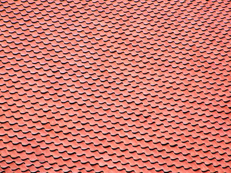 The texture of the red roof of a medieval castle, made of red clay tilesの写真素材
