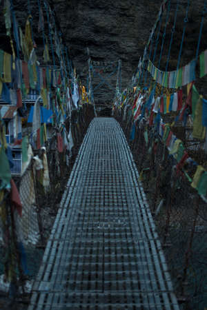 Chame suspension bridge colorful buddhist prayer flags over Marshyangdi river, Annapurna circuit, Nepalの写真素材