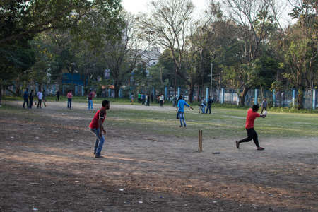 Kolkata, India - February 1, 2020: Several unidentified people plays cricket in everyday clothes in Minhaj Gardan park on February 1, 2020 in Kolkata, Indiaのeditorial素材